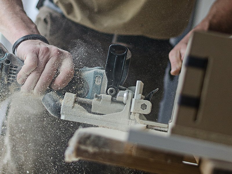 A joiner machining a timber component in the Spittlywood workshop