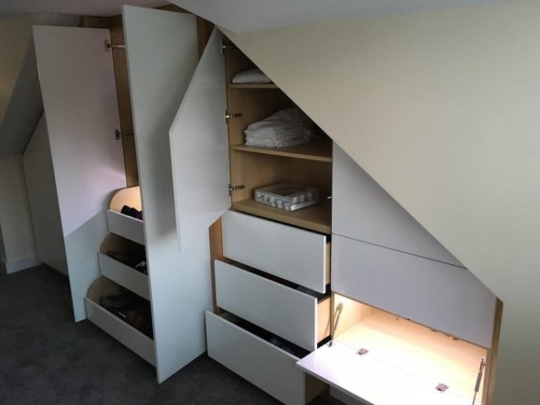 White eaves drawers and storage under a sloping roof