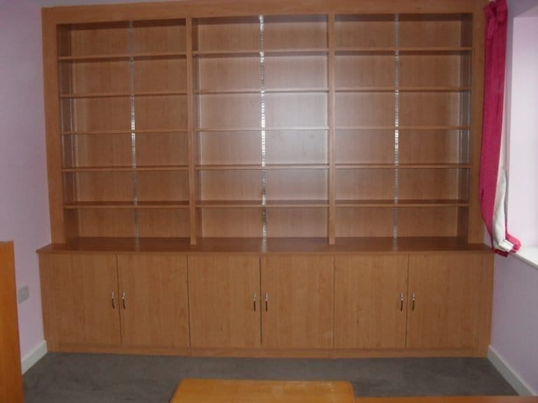Floor to ceiling timber shelving with cupboards below