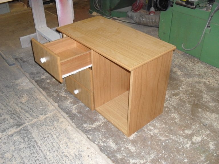 Timber drawer unit with one drawer open in a workshop