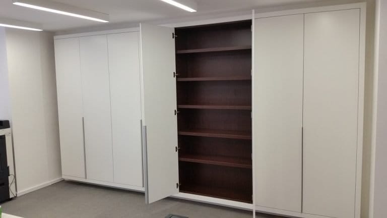 White fitted wardrobes with a dark timber open shelf section