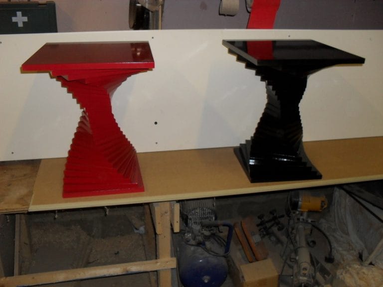 Pair of red and black sculptural pedestal tables