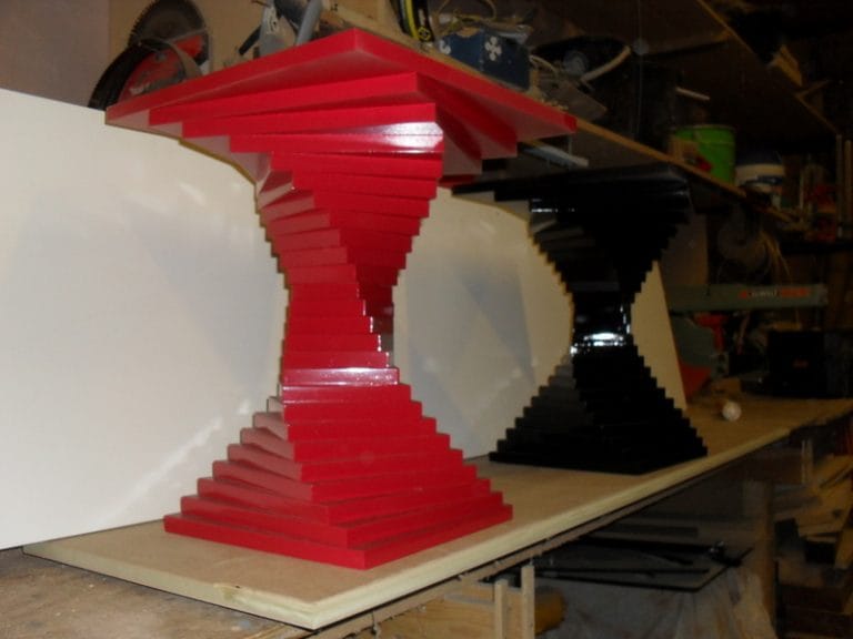 Close up of red and black stacked pedestal table bases