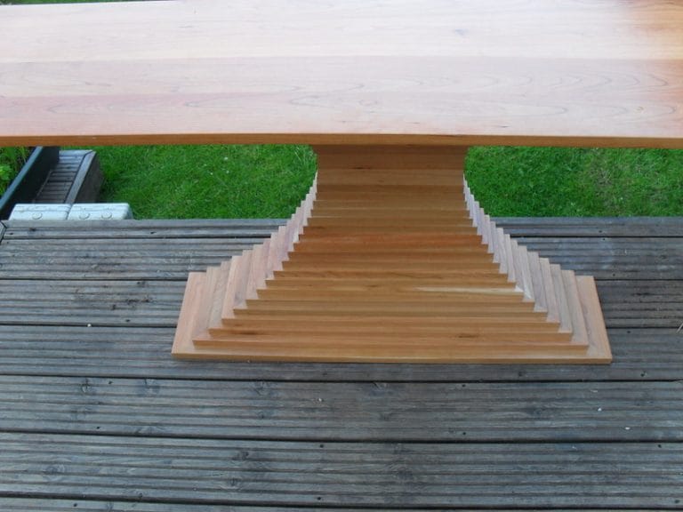 Stepped timber table base on outdoor decking
