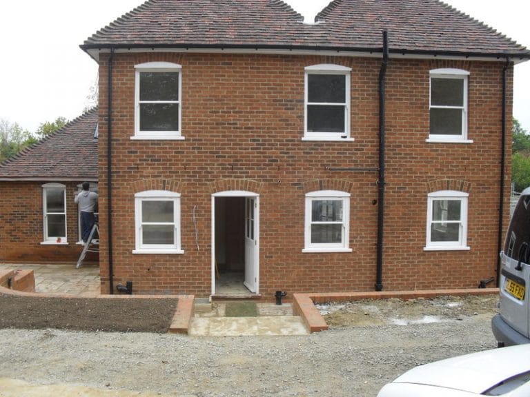 Red brick house with new white timber sash windows
