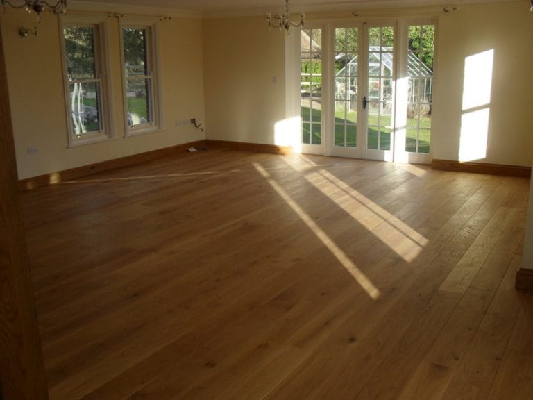 Sunlit room with timber windows and French doors over a wood floor