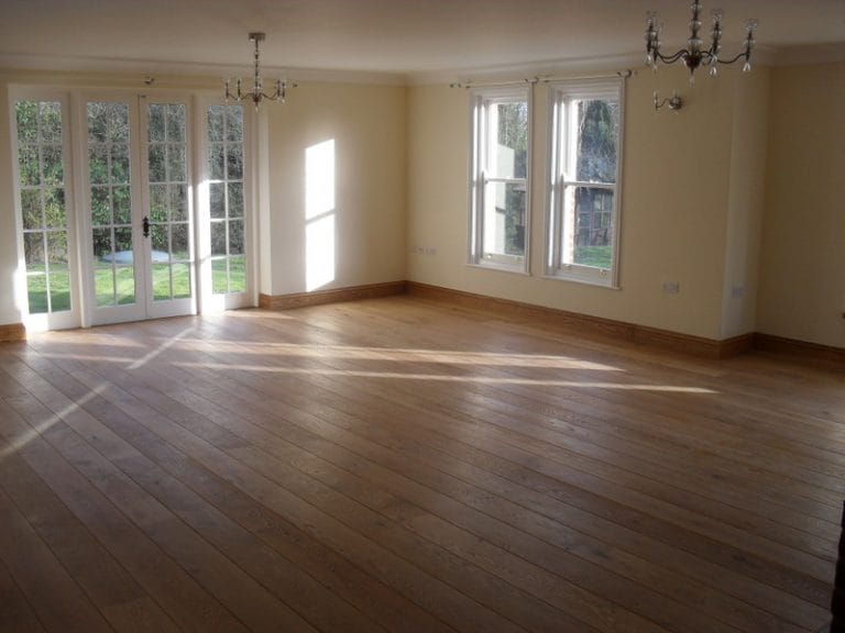 Empty room with white timber windows and a new timber floor