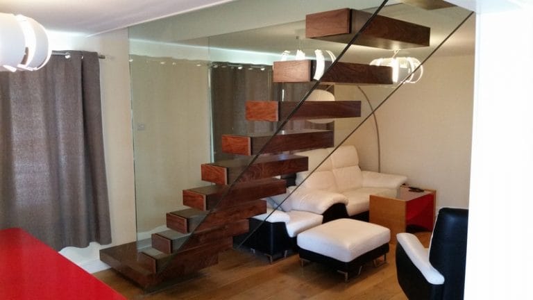Floating timber staircase with glass balustrade in a lounge