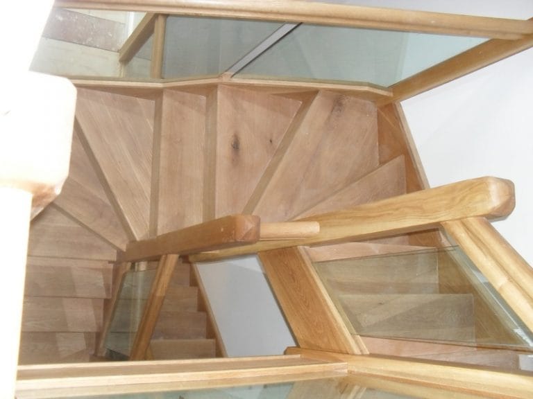 Timber winder staircase with glass panels, viewed from above