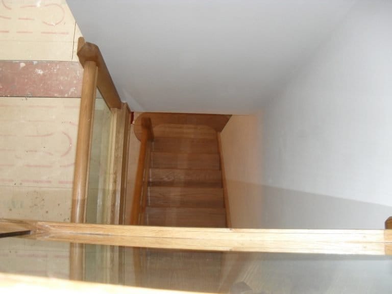 Timber handrail across the head of a narrow staircase