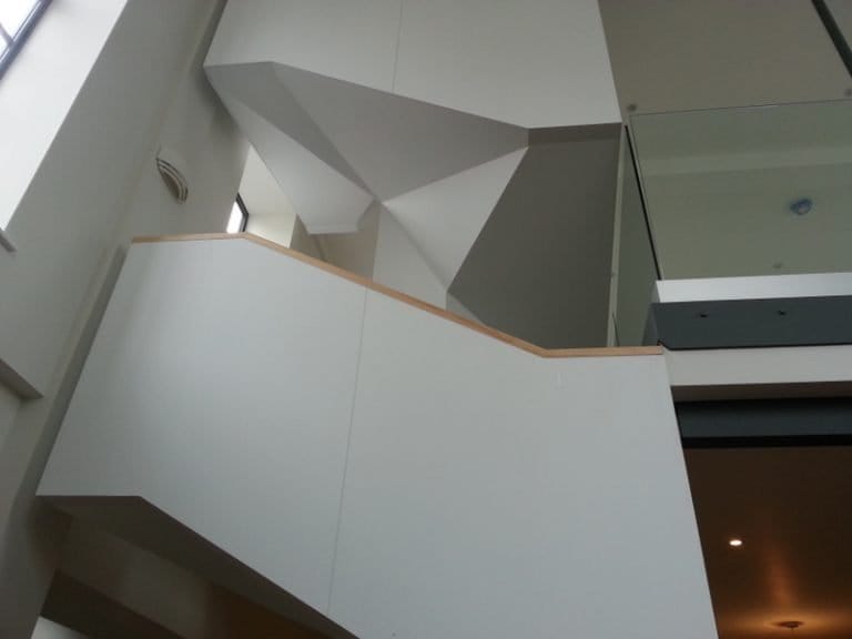Solid white balustrade with timber capping on a modern staircase