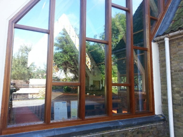 Tall hardwood window frames on a church building