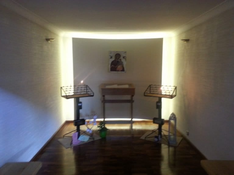 Small chapel with a timber altar and candle stands