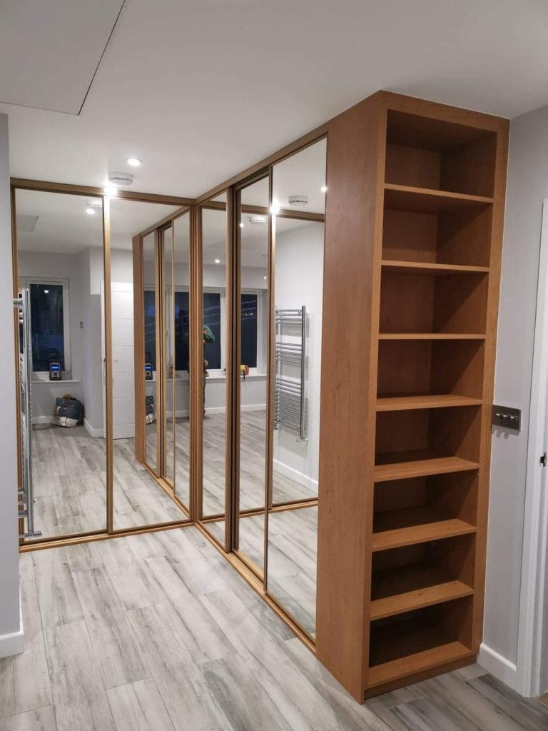 Fitted wardrobe with mirror doors and timber shelf unit