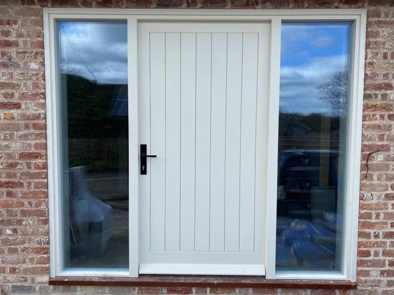 Cream vertical boarded door with tall glazed side panels