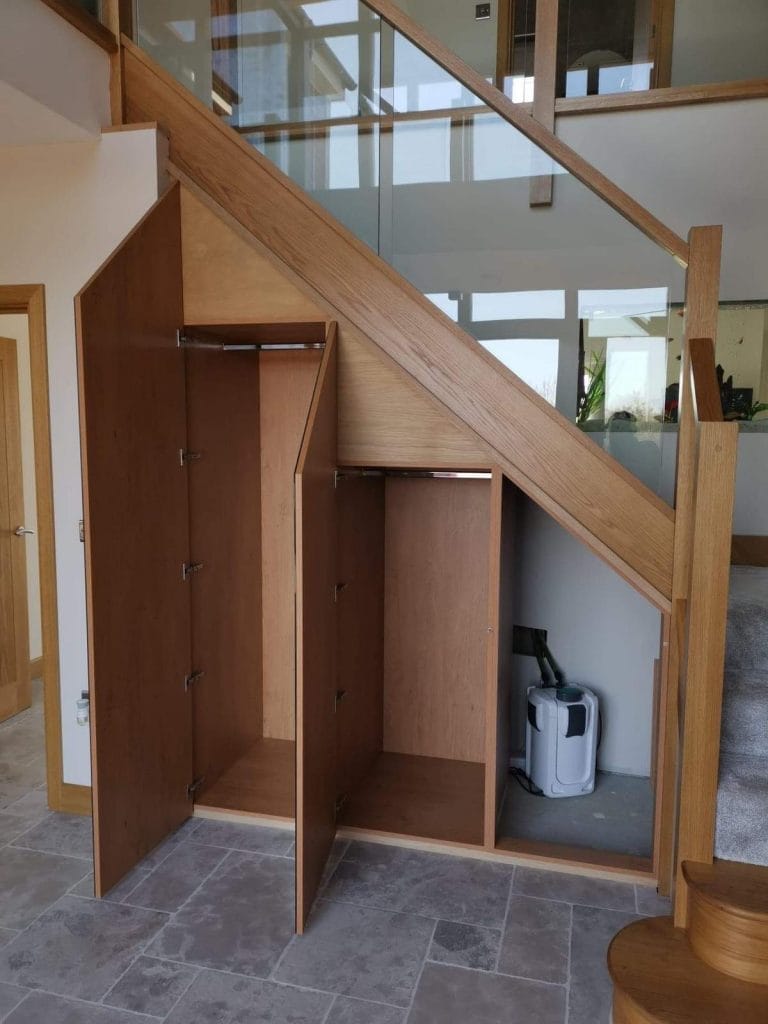 Timber cupboards fitted under a staircase