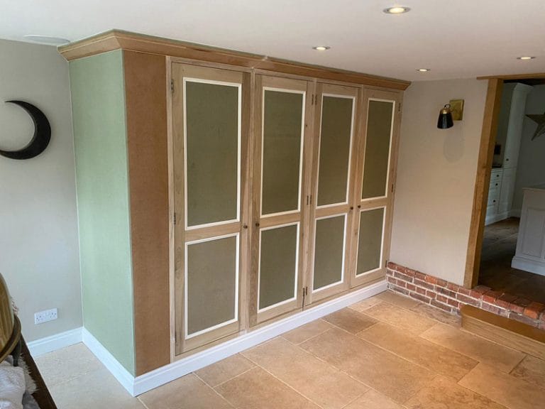 Run of timber and frosted glass fitted cupboards