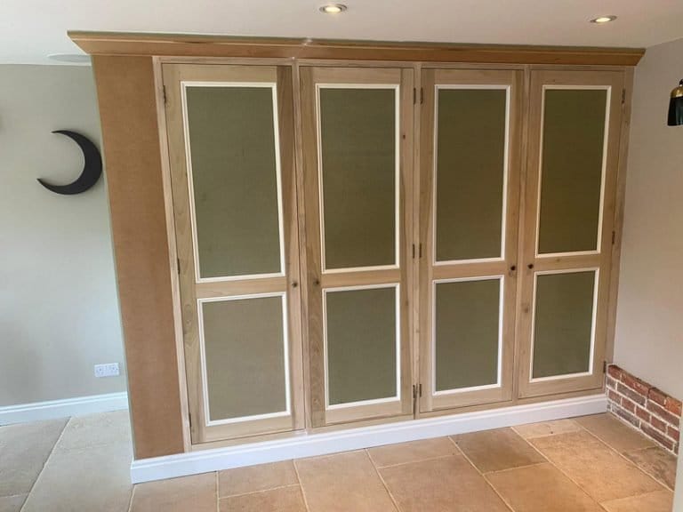 Timber fitted cupboards with frosted glass inserts on a timber floor