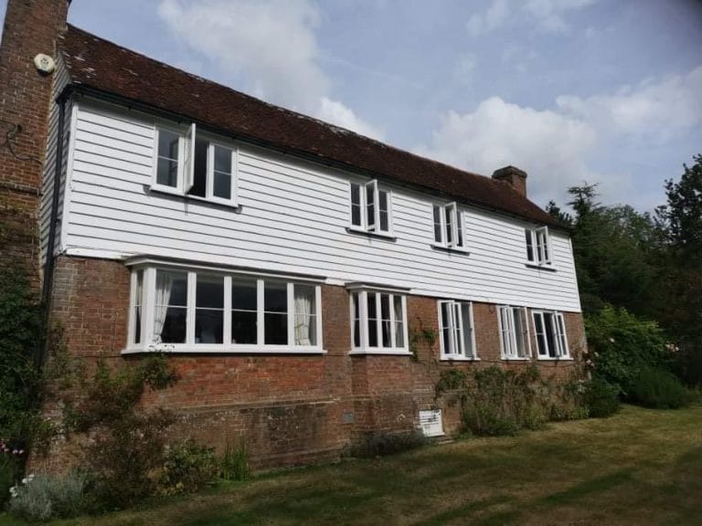 White timber casement windows on a tile hung farmhouse