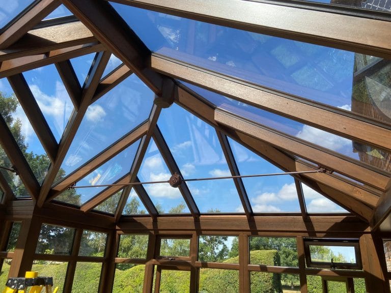 Glazed timber conservatory roof with ridge finials, viewed from inside