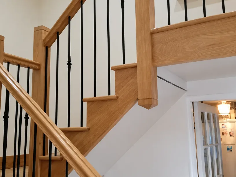 Oak staircase with black metal spindles, made by Spittlywood