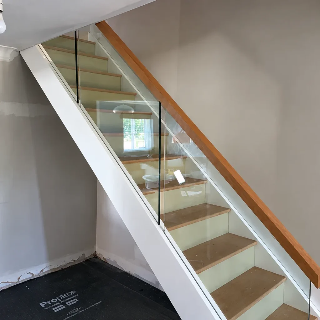 Oak treads and glass balustrade on a bespoke staircase in Kent